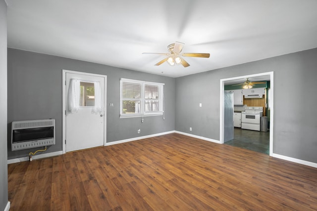 407 N Pine St, Pierce City, MO 65723 - unfurnished living room with heating unit, ceiling fan, and wood finished floors