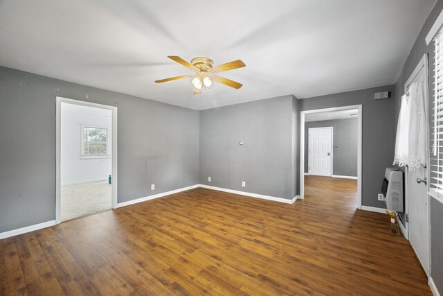 407 N Pine St, Pierce City, MO 65723 - spare room with heating unit, a ceiling fan, and dark wood-type flooring