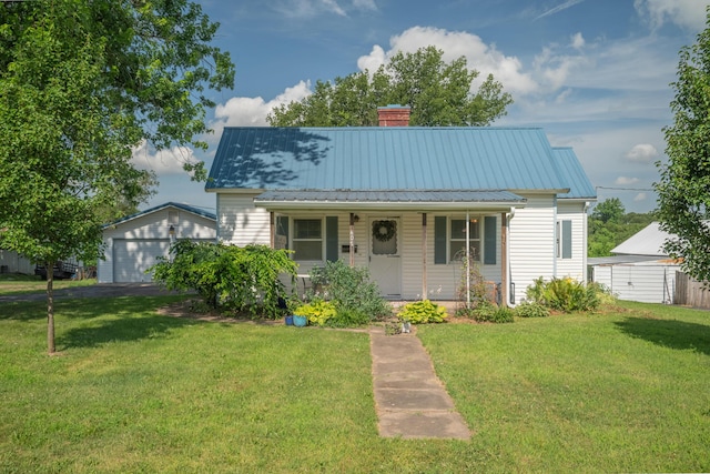 407 N Pine St, Pierce City, MO 65723 - view of front facade with a porch, a garage, a front lawn, a metal roof, and an outdoor structure