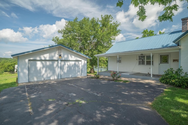 407 N Pine St, Pierce City, MO 65723 - view of side of home with a detached garage, an outdoor structure, and a metal roof