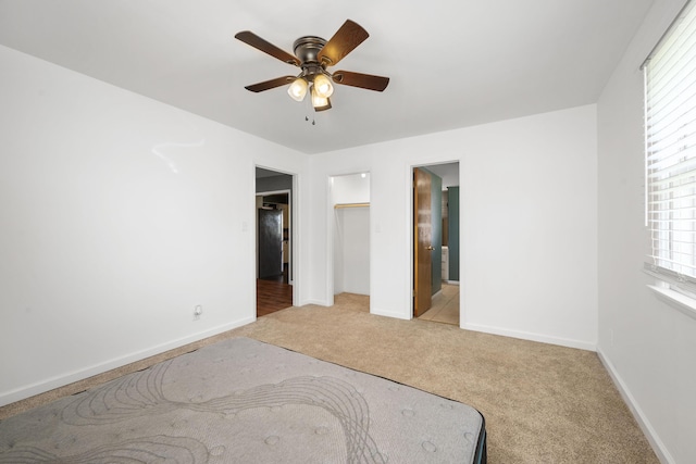 407 N Pine St, Pierce City, MO 65723 - unfurnished bedroom featuring light colored carpet, multiple windows, ceiling fan, and connected bathroom