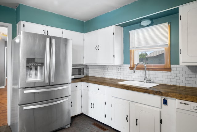 407 N Pine St, Pierce City, MO 65723 - kitchen featuring appliances with stainless steel finishes, white cabinets, and tasteful backsplash