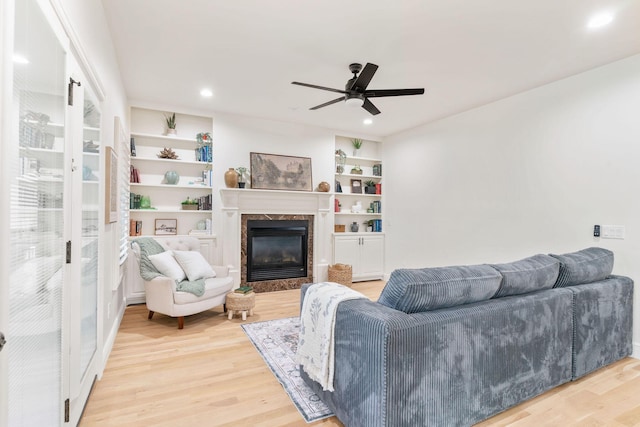 1303 E Eaglegate Pkwy, Springfield, MO 65804 - living room featuring light wood-type flooring, a premium fireplace, ceiling fan, recessed lighting, and built in shelves