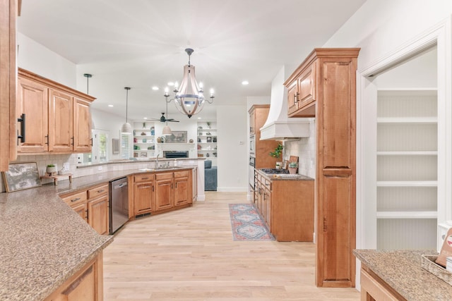 1303 E Eaglegate Pkwy, Springfield, MO 65804 - kitchen featuring open floor plan, stainless steel appliances, a chandelier, a peninsula, and tasteful backsplash