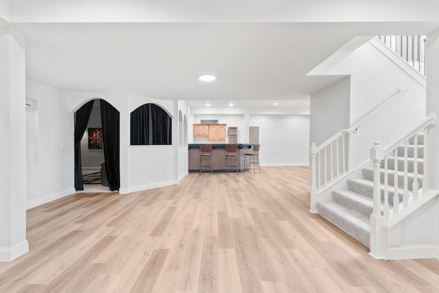 1303 E Eaglegate Pkwy, Springfield, MO 65804 - living area with stairway, light wood-style flooring, arched walkways, and recessed lighting