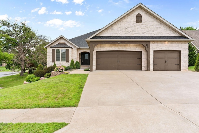 1303 E Eaglegate Pkwy, Springfield, MO 65804 - french provincial home with a front lawn, an attached garage, stone siding, concrete driveway, and a shingled roof