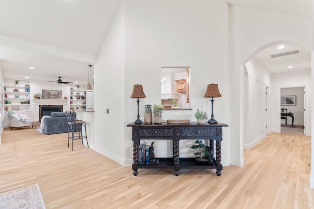 1303 E Eaglegate Pkwy, Springfield, MO 65804 - hall with arched walkways, light wood-style floors, a towering ceiling, and recessed lighting