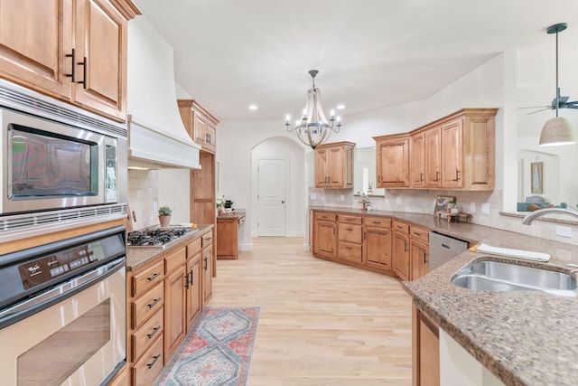 1303 E Eaglegate Pkwy, Springfield, MO 65804 - kitchen with appliances with stainless steel finishes, premium range hood, tasteful backsplash, light stone countertops, and recessed lighting