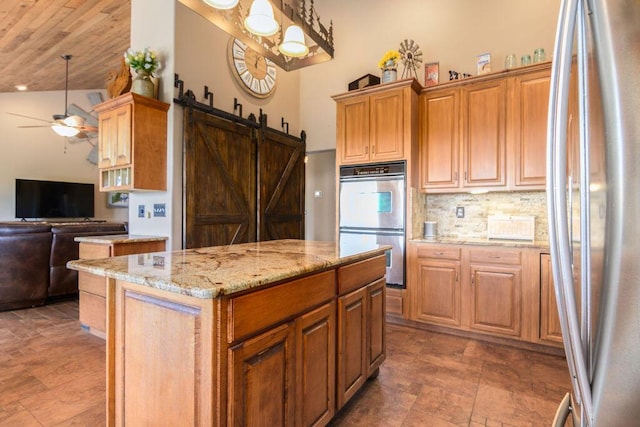 10626 W State Highway 76, Cape Fair, MO 65624 - kitchen featuring stainless steel appliances, stone finish flooring, a kitchen island, and open floor plan