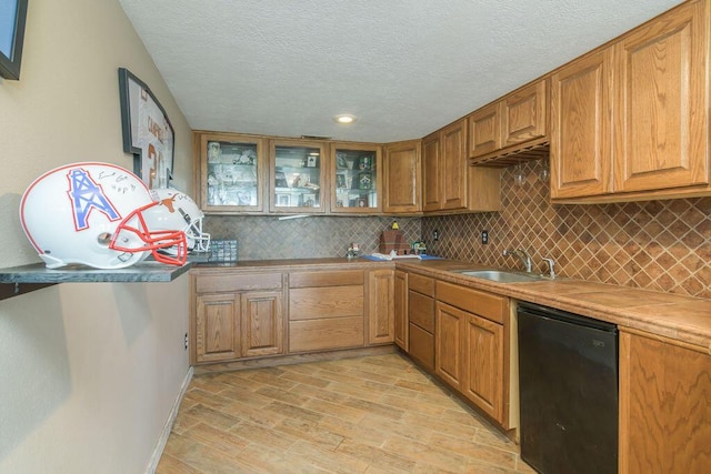 10626 W State Highway 76, Cape Fair, MO 65624 - kitchen with a textured ceiling, backsplash, light wood finished floors, glass insert cabinets, and dishwasher