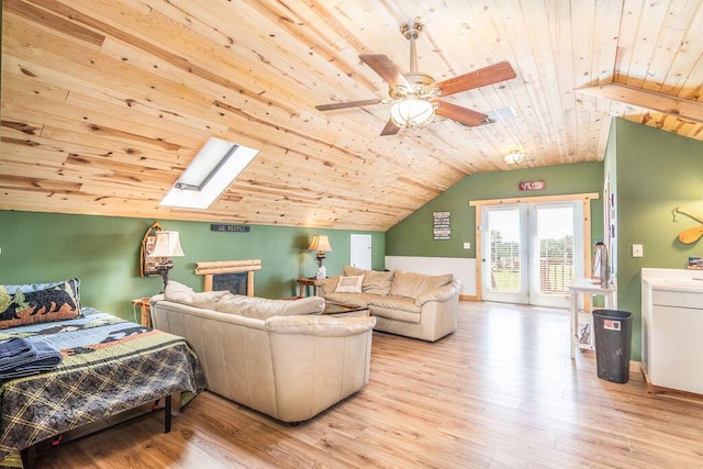 10626 W State Highway 76, Cape Fair, MO 65624 - living area featuring wood ceiling, vaulted ceiling, light wood-style floors, a ceiling fan, and a skylight