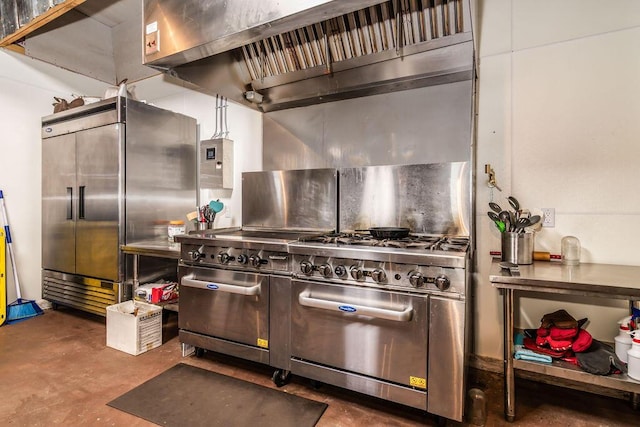 10626 W State Highway 76, Cape Fair, MO 65624 - kitchen with high end appliances, wall chimney range hood, and concrete flooring