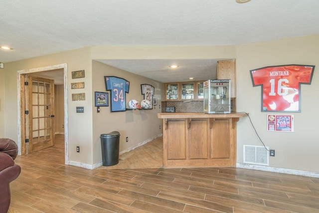 10626 W State Highway 76, Cape Fair, MO 65624 - bar area featuring wood finished floors, decorative backsplash, recessed lighting, and a textured ceiling