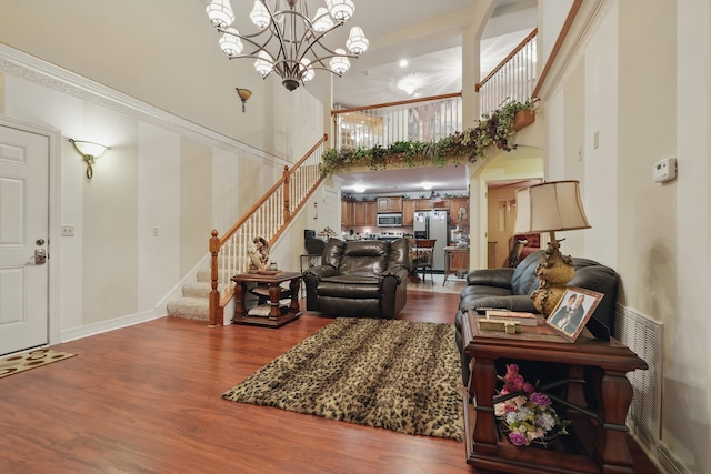 180 Grace Chapel Rd Unit 325, Blue Eye, MO 65611 - living area with stairway, dark wood-type flooring, a towering ceiling, and a chandelier