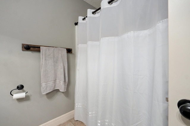 4531 W Somerset Dr, Battlefield, MO 65619 - bathroom with a shower with shower curtain and tile patterned floors