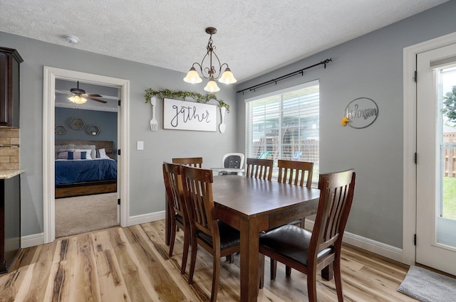4531 W Somerset Dr, Battlefield, MO 65619 - dining room with light wood-style flooring, a textured ceiling, healthy amount of natural light, and a chandelier