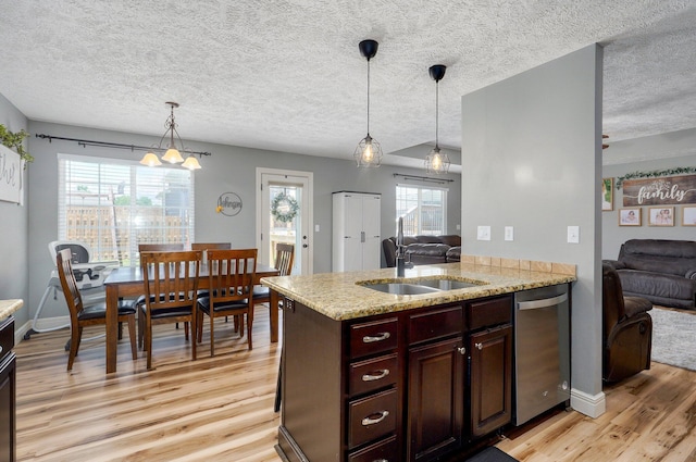 4531 W Somerset Dr, Battlefield, MO 65619 - kitchen with dishwasher, light wood-type flooring, open floor plan, healthy amount of natural light, and a textured ceiling