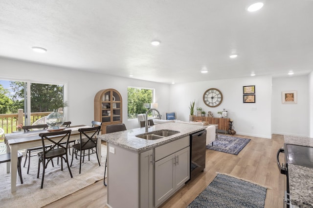 202 N Cheyenne Valley Rd, Nixa, MO 65714 - kitchen with recessed lighting, black dishwasher, a center island with sink, light wood-type flooring, and light stone counters