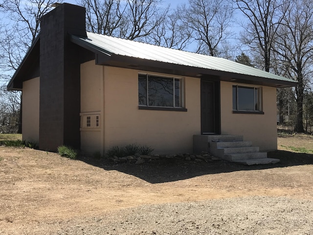 462 Campbell Point Rd, Shell Knob, MO 65747 - view of front of home with a chimney, entry steps, a metal roof, and stucco siding
