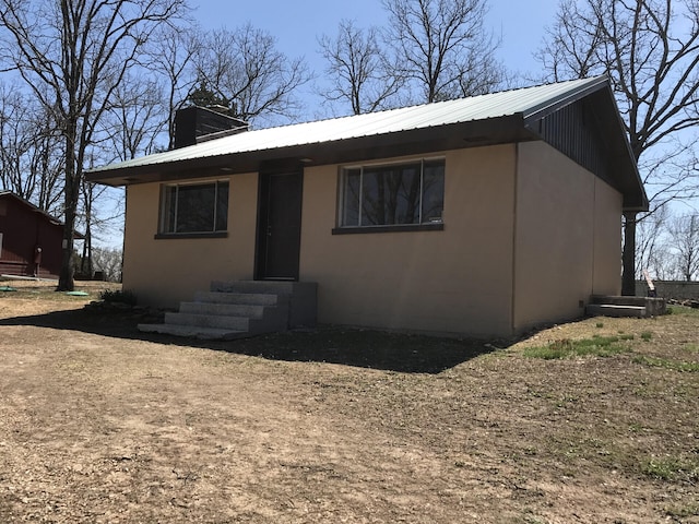 462 Campbell Point Rd, Shell Knob, MO 65747 - view of front of home with entry steps, a metal roof, and stucco siding