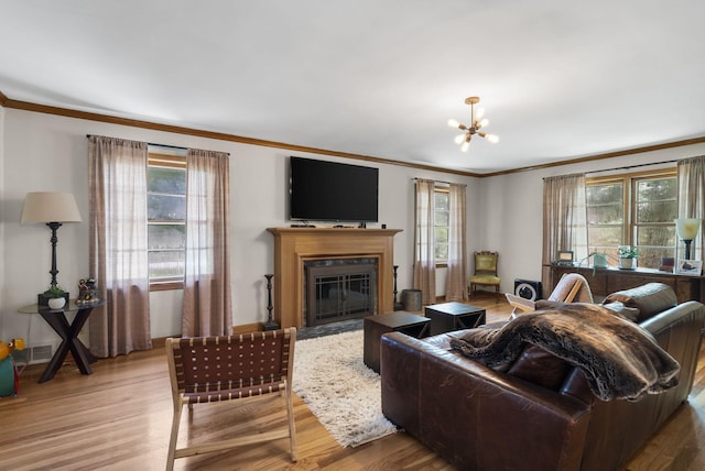 1471 E Bennett St, Springfield, MO 65804 - living area with crown molding, wood finished floors, a fireplace with flush hearth, and a chandelier