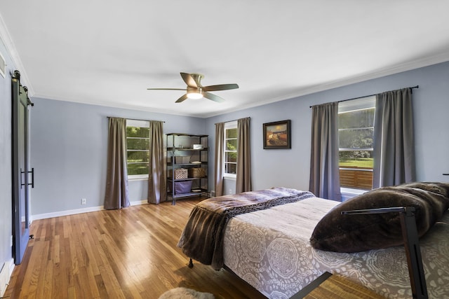 1471 E Bennett St, Springfield, MO 65804 - bedroom featuring multiple windows, wood finished floors, crown molding, a barn door, and a ceiling fan