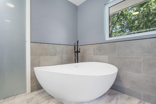 1471 E Bennett St, Springfield, MO 65804 - bathroom with tile walls, a freestanding tub, and wainscoting