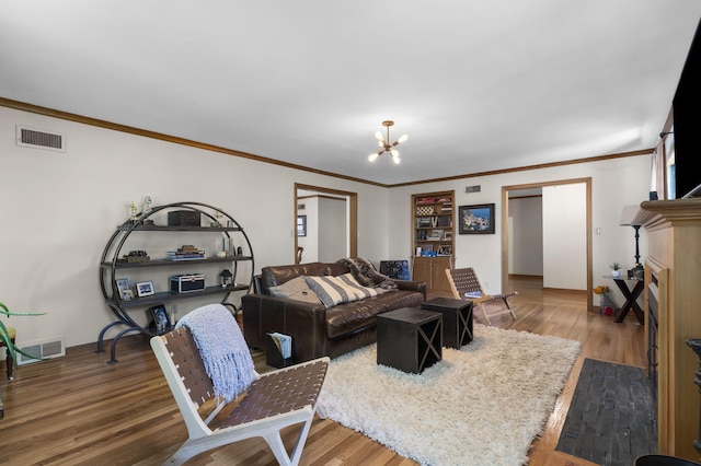 1471 E Bennett St, Springfield, MO 65804 - living room with a chandelier, wood finished floors, and crown molding