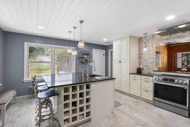 1471 E Bennett St, Springfield, MO 65804 - kitchen featuring electric range, dark countertops, light wood-style floors, cream cabinetry, and recessed lighting