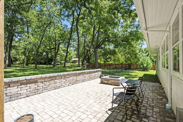 1471 E Bennett St, Springfield, MO 65804 - fenced backyard featuring a patio, an outdoor fire pit, and view of wooded area