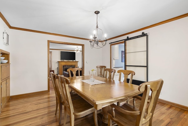 1471 E Bennett St, Springfield, MO 65804 - dining area with ornamental molding, light wood finished floors, a chandelier, and a fireplace