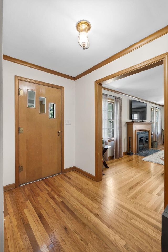 1471 E Bennett St, Springfield, MO 65804 - entryway with wood finished floors, ornamental molding, and a fireplace with flush hearth