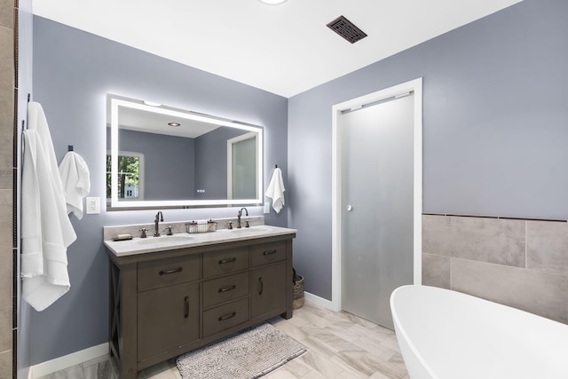 1471 E Bennett St, Springfield, MO 65804 - full bath with double vanity, a freestanding tub, and marble look tiles