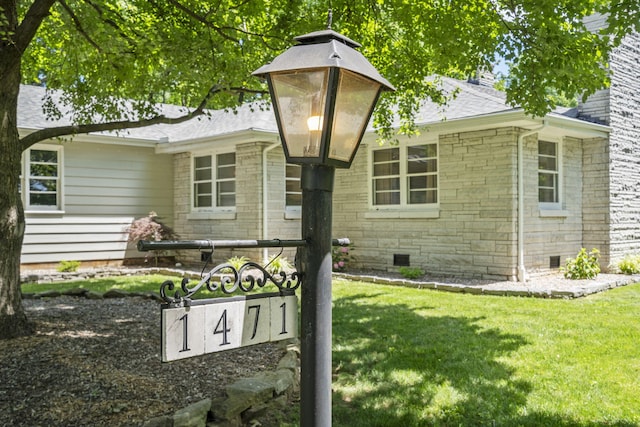 1471 E Bennett St, Springfield, MO 65804 - exterior view of crawl space, a downspout, gutters, and roof with shingles