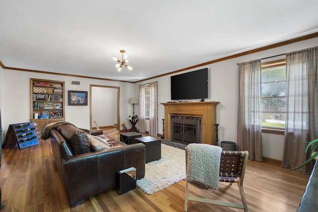 1471 E Bennett St, Springfield, MO 65804 - living area with wood finished floors, ornamental molding, a chandelier, and a fireplace with flush hearth
