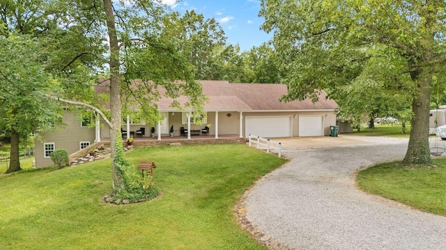 1850 E Farm Road 88, Springfield, MO 65803 - view of front of house featuring gravel driveway, an attached garage, and a front lawn