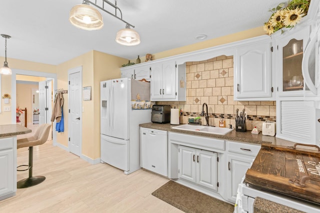1850 E Farm Road 88, Springfield, MO 65803 - kitchen featuring white appliances, tasteful backsplash, white cabinets, and hanging light fixtures