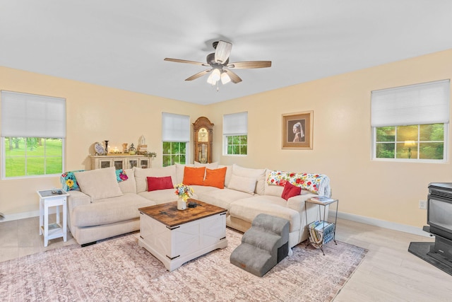 1850 E Farm Road 88, Springfield, MO 65803 - living area featuring a wood stove, a ceiling fan, and light wood-style flooring