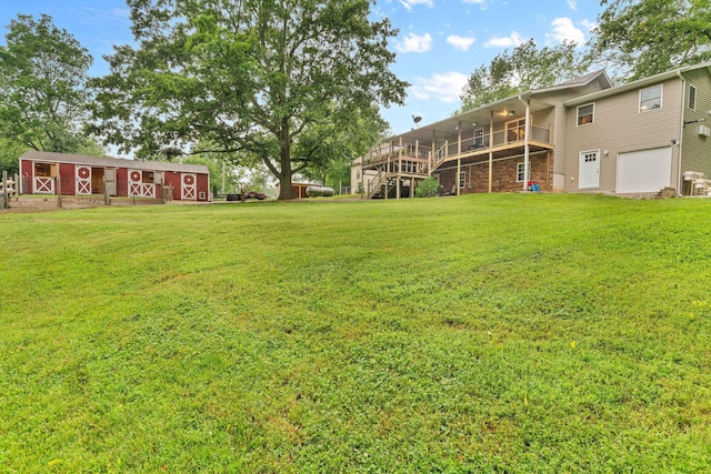1850 E Farm Road 88, Springfield, MO 65803 - view of grassy yard featuring an attached garage, stairs, a deck, and an outbuilding