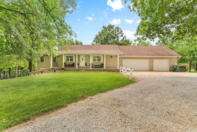 1850 E Farm Road 88, Springfield, MO 65803 - ranch-style house with gravel driveway, covered porch, a garage, and a front yard