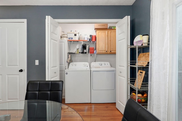 801 S Creekwood Ct, Nixa, MO 65714 - laundry room featuring cabinet space, washer and clothes dryer, and light wood-type flooring