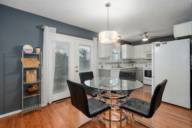 801 S Creekwood Ct, Nixa, MO 65714 - dining space featuring light wood-type flooring, french doors, and ceiling fan