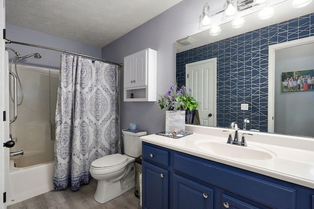 801 S Creekwood Ct, Nixa, MO 65714 - bathroom featuring wood finished floors, vanity, shower / bathtub combination with curtain, and a textured ceiling