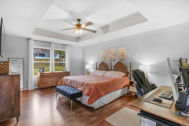 676 E Gallup Hill Rd, Nixa, MO 65714 - bedroom featuring a tray ceiling, wood finished floors, an office area, and a ceiling fan