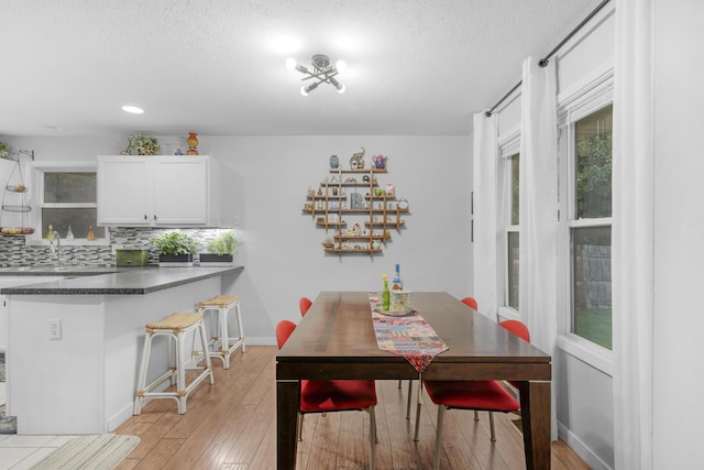 676 E Gallup Hill Rd, Nixa, MO 65714 - dining area featuring light wood-style floors, a textured ceiling, and recessed lighting