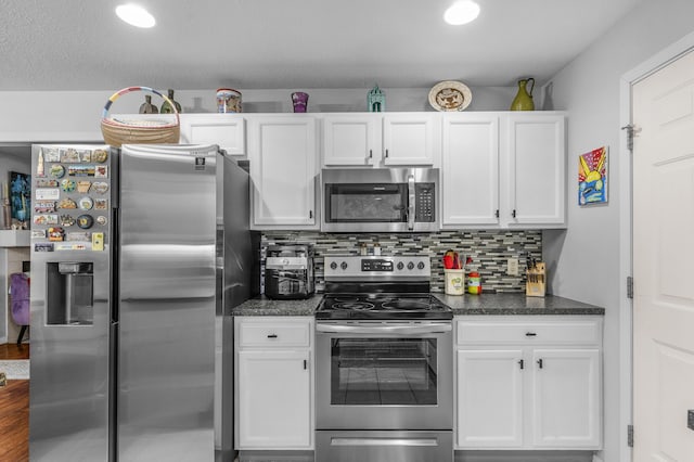 676 E Gallup Hill Rd, Nixa, MO 65714 - kitchen featuring stainless steel appliances, white cabinets, decorative backsplash, and dark countertops