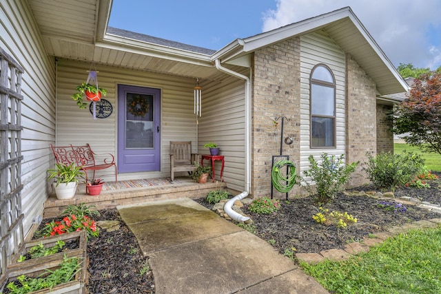 676 E Gallup Hill Rd, Nixa, MO 65714 - property entrance featuring a porch, brick siding, and a shingled roof