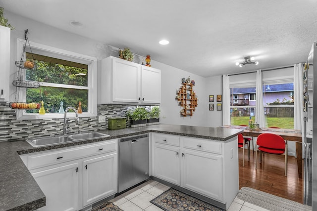 676 E Gallup Hill Rd, Nixa, MO 65714 - kitchen with dishwasher, a peninsula, decorative backsplash, white cabinetry, and recessed lighting