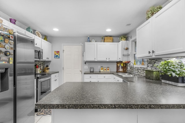 676 E Gallup Hill Rd, Nixa, MO 65714 - kitchen featuring appliances with stainless steel finishes, backsplash, white cabinetry, dark countertops, and recessed lighting