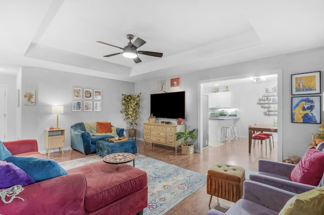 676 E Gallup Hill Rd, Nixa, MO 65714 - living room with a raised ceiling, ceiling fan, and wood finished floors